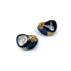 Moritz Audio ENZO Flagship In-Ear Monitors, dark navy blue with gold flake accents, visible 'Moritz' brand name on one earpiece and a logo on the other.