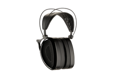 Black Audeze MM-500 headphones with a quilted leather headband, metal frame, and large earcups with a honeycomb design. Close-up, side view.