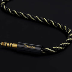 Rope-style audio cable with gold and black connector on a dark background, featuring the brand 'Zikman'.