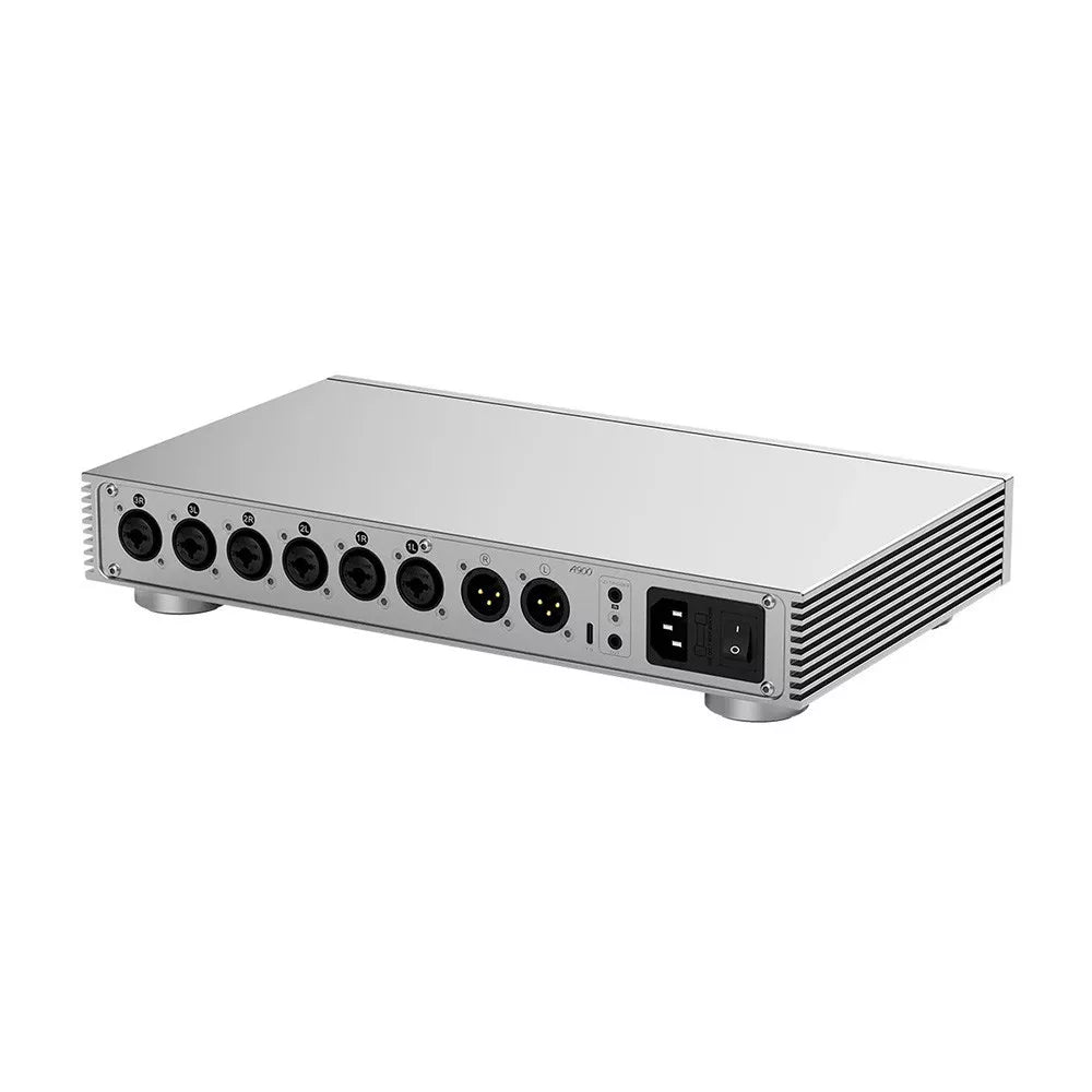 Silver audio interface with multiple ports on a white background